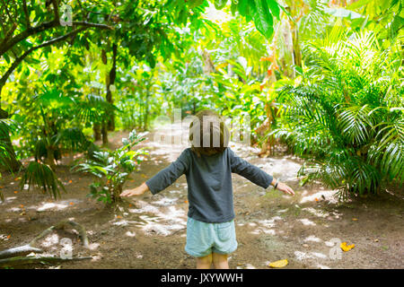 Carefree Caucasian boy standing on path Stock Photo