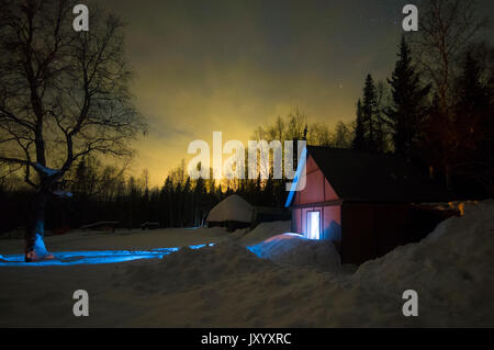 Light glowing in remote barn in winter Stock Photo