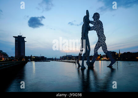 Dusk view of Molecule Man sculpture on Spree River in Berlin, Germany