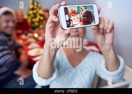Modern grandmother taking a photo of the family Stock Photo