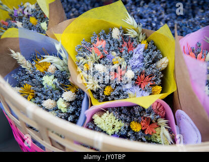 Bouquets of flowers in a basket on the market Stock Photo