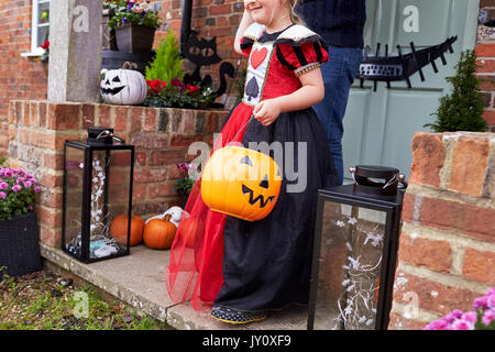 Father And Daughter Outside House Trick Or Treating Stock Photo