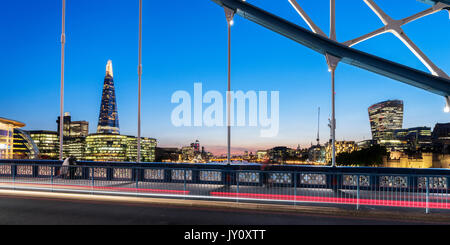 UK, London, Tower Bridge and the city skyline, including the view of the Shard and the Walkie Talkie tower, lit up twilight Stock Photo