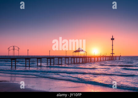 People walking along Brighton Beach jetty at sunset, South Australia Stock Photo