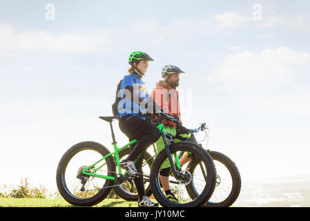 Caucasian couple riding bicycles Stock Photo