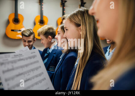 Close up shot of choir students singing in their music lesson at school. Stock Photo