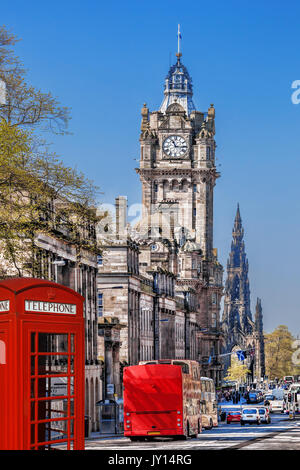 Edinburgh with phone booths and red bus against clocktower in Scotland, UK Stock Photo