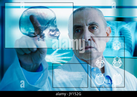 Hispanic doctor using virtual computer screen Stock Photo