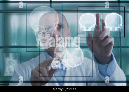 Hispanic doctor using virtual computer screen Stock Photo