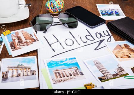 Photos Of Holiday On Wooden Desk With Sunglasses And Smartphone Stock Photo