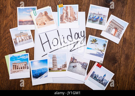 High Angle View Of Photos Of Holiday On Wooden Desk Stock Photo