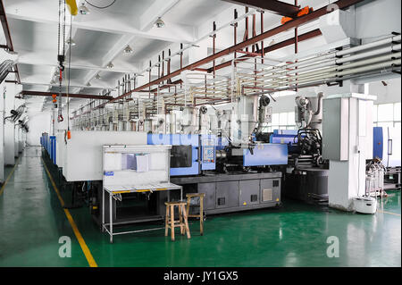 Row of plastic injection CNC machines at empty workshop Stock Photo