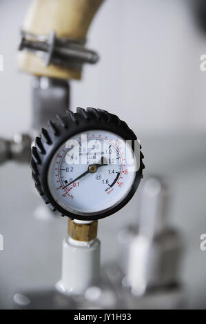 Closeup of pressure vacuum gauge with tube on background Stock Photo