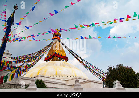 Bodhnath Stupa Temple and praying flag. Boudhanath Stupa (or Bodnath Stupa) is the largest stupa in Nepal and the holiest Tibetan Buddhist temple outs Stock Photo