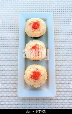 Three cupcakes on white plate Stock Photo