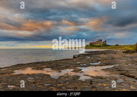 Bamburgh castle sunrise on the Northumberland coastline Stock Photo