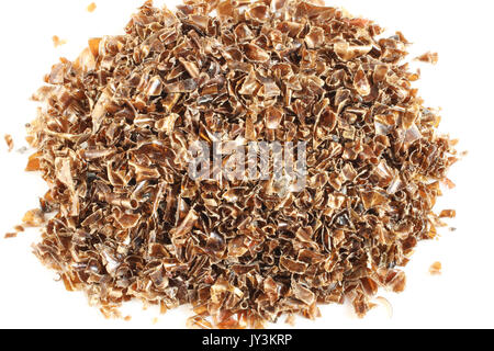 Small pieces of cut brown plastic bottles on white paper Stock Photo