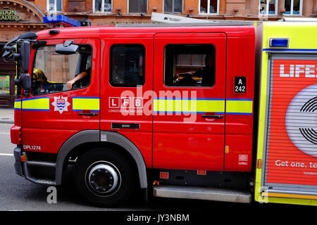 A fire engine of the London Fire Brigade returns along Shaftesbury Avene in London's West End, to Soho Fire Station Stock Photo
