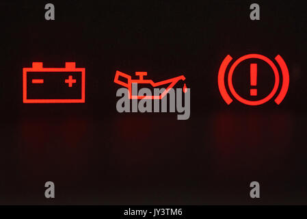 Macro of error signs in car. Red icons of battery, oil and hand break Stock Photo