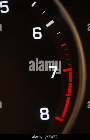 Close-up of car tachometer indicator. Red rpm zone Stock Photo