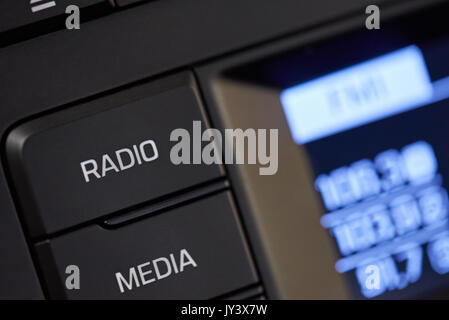 Car radio knob close-up. Digital media in car interior Stock Photo