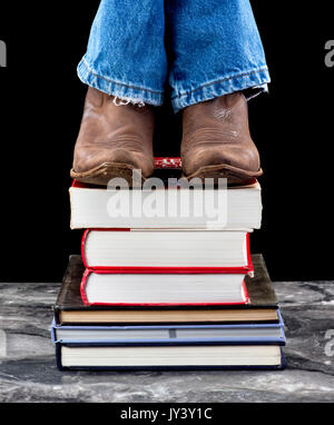 Stepping up high on schools books. Stock Photo