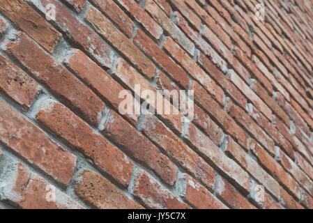 Red brick wall texture grunge background with film matt effect in perspective view. Selective focus Stock Photo