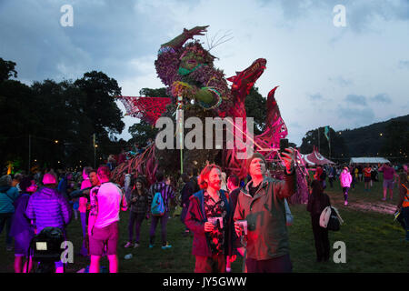 Glanusk Park, Brecon, Wales, 17th August 2017.  The start of The Green Man music festival in the Brecon Beacons Mountains in Wales. This year the giant wicker man is in the shape of a dragon. It’s the day before the music officially starts and the sell-out crowd of 20,000 have come prepared for a weekend of bad weather. Credit: Rob Watkins/Alamy Live News Stock Photo