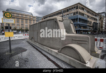 A gray concrete bus is still fenced off in the central Rathenauplatz in Frankfurt am Main, Germany, 18 August 2017. The traveling 'Gray bus monument' is to conmemorate the victims of the 'euthanasia' of those with mental illnesses and the mentally impaired during the times of national-socialism between 19 August 2017 and May 2018. Photo: Frank Rumpenhorst/dpa Stock Photo