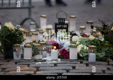 Turku, Finland. 19th of August 2017. Candles and flowers for the victims of knife attack in Turku market square. Two people have been killed and six others wounded in a knife attack that took place on friday 18th of august at Turku market square and Puutori. The police was able to stop the attacker within minutes after the first emergency call by shooting him at thigh. Police is investigating the attack as an act of terrorism. Credit: Jarmo Piironen/Alamy Live News Stock Photo