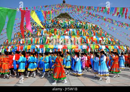 Bayan Nur, China's Inner Mongolia Autonomous Region. 18th Aug, 2017. Herdsmen attend an annual Aobao Worship Festival in Bayan Nur, north China's Inner Mongolia Autonomous Region, Aug. 18, 2017. People of the Mongolian ethnic group here dressed in their traditional costumes celebrated Friday the Aobao Worship Festival to pray for a good life. Credit: Zhi Maosheng/Xinhua/Alamy Live News Stock Photo