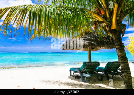 relaxing beach scenery with umbrellas and beach chairs. Luxury vacations in Mauritius island Stock Photo