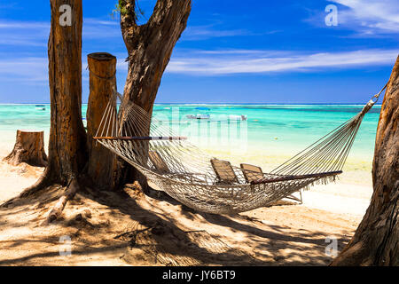 relaxing tropical vacation. Hammock in the shade of trees. Mauritius island Stock Photo