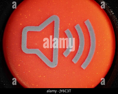 Fluorescent red alarm button from car key fob, ultraviolet + visible light micrograph, 12x magnification when printed 10cm wide Stock Photo