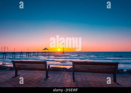 Brighton Beach view with people walking along jetty at sunset, South Australia Stock Photo