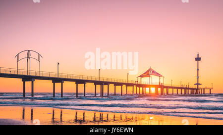 People walking along Brighton Beach jetty at sunset, South Australia Stock Photo