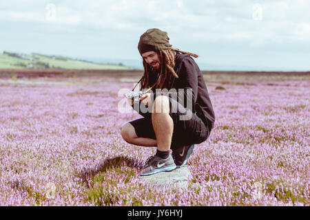 Bearded Photographer With Dreadlocks Takes Photograph With Vintage Rangefinder Camera Stock Photo