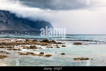 Beautiful landscape of Betty's Bay, mountains in the fog near seashore, beauty of wild nature, Atlantic Ocean, South Africa Stock Photo