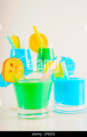 Colorful cocktail decorated with fruit, colorful umbrella, ice cubes, party night, mix drink Stock Photo