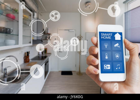 Smart home interface on smartphone app screen with augmented reality (AR) view of internet of things (IOT) connected objects in the appartment interio Stock Photo