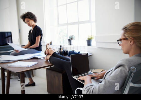 Two businesswomen working together in an office Stock Photo