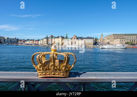 View towards historic Old Town of Stockholm from Skeppsholmen bridge with its Royal crown. The capital city of Sweden is built on 17 islands. Stock Photo
