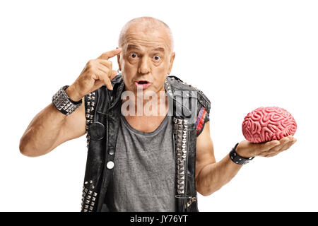 Elderly punker with a brain model holding a finger on his temple asking do you have a brain isolated on white background Stock Photo