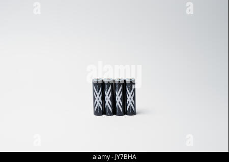 Hai, Ukraine - August 10, 2017: close-up photo of four black batteries on white background. Stock Photo