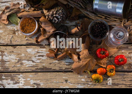 Overhead view of spice by container on wooden table Stock Photo