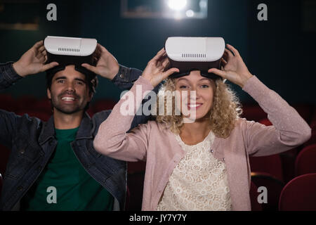 Couple using virtual reality headset in theatre Stock Photo