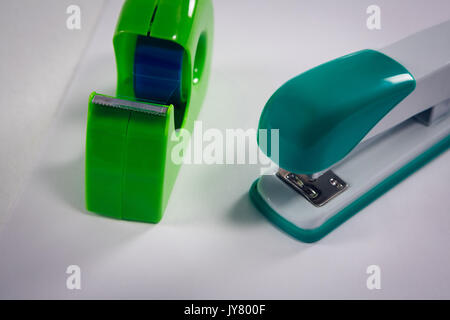 Close-up of stapler and cello tape on white background Stock Photo