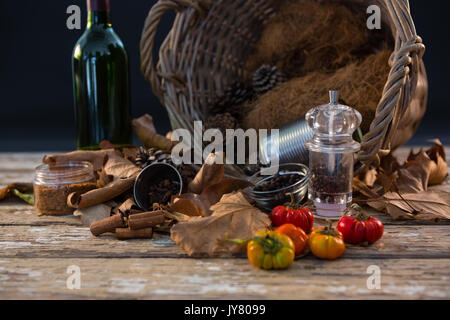 Spice by container on wooden table against black background Stock Photo