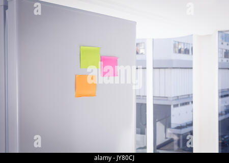 Adhesive notes stuck on refrigerator Stock Photo