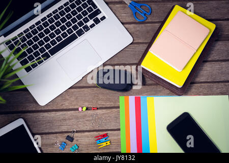Laptop and digital tablet with office supplies on wooden table Stock Photo